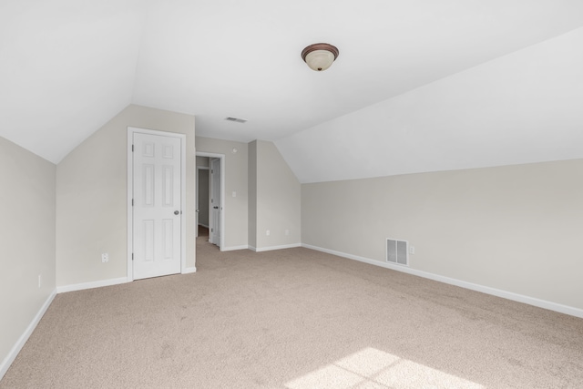 bonus room with carpet floors, vaulted ceiling, visible vents, and baseboards
