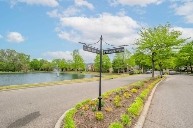 view of road with curbs and a water view