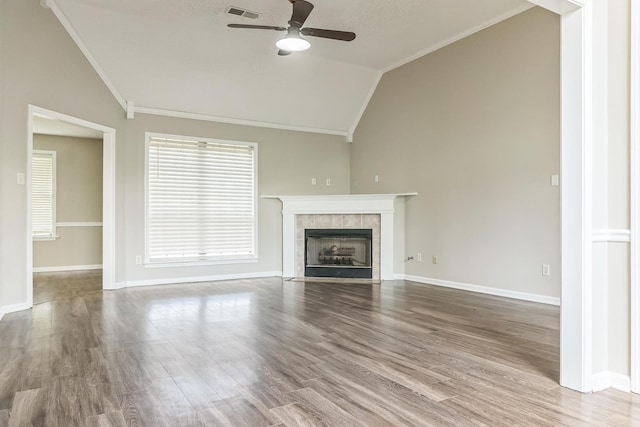 unfurnished living room with a fireplace, a ceiling fan, crown molding, visible vents, and lofted ceiling