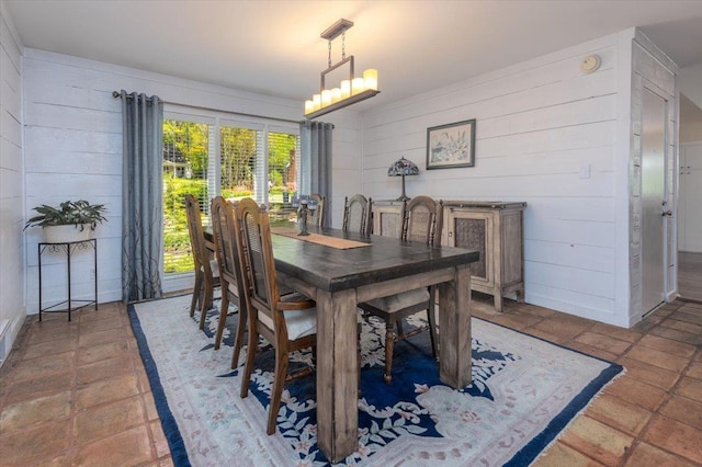 dining room featuring wooden walls