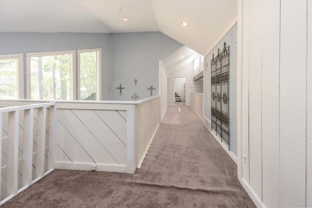 hall featuring carpet flooring, lofted ceiling, and recessed lighting