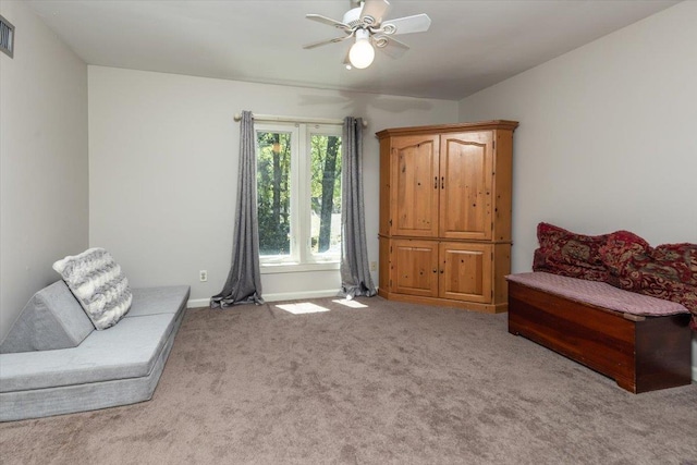 sitting room with ceiling fan, baseboards, visible vents, and carpet floors