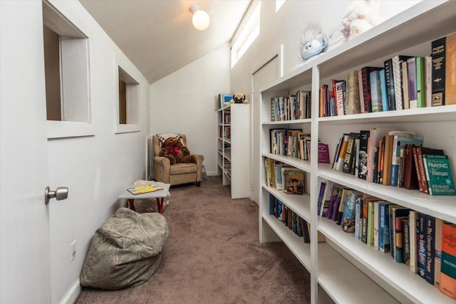 sitting room featuring carpet and vaulted ceiling