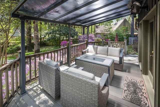 wooden deck with an outdoor living space