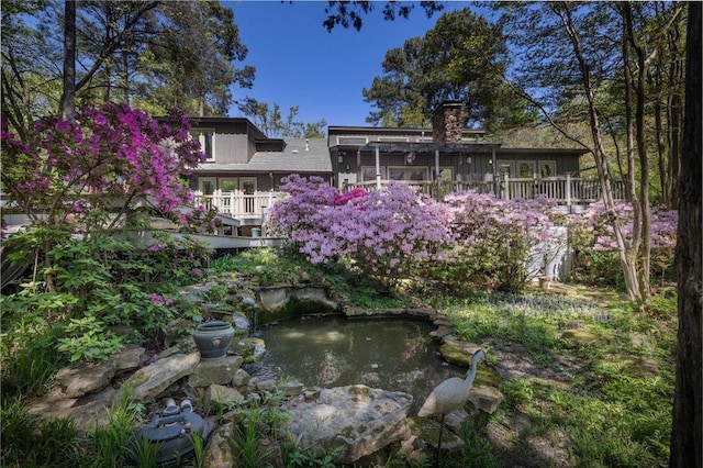 exterior space with a garden pond