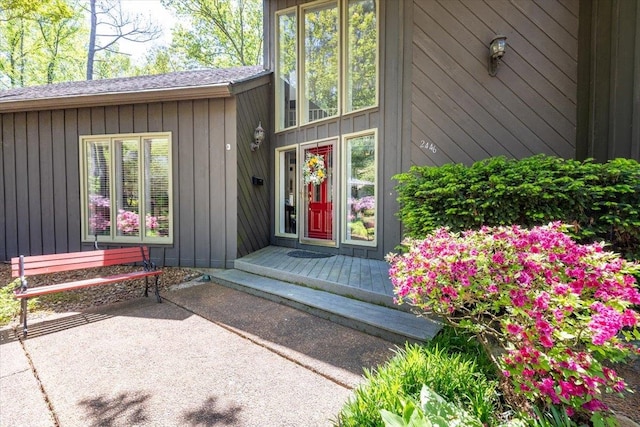 entrance to property with a patio and board and batten siding