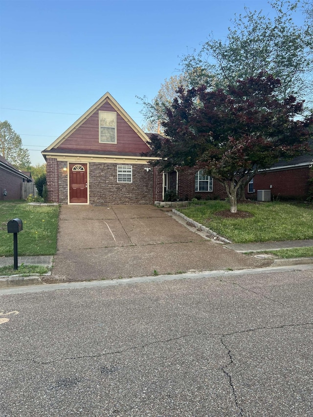 view of front of house with a front yard and brick siding
