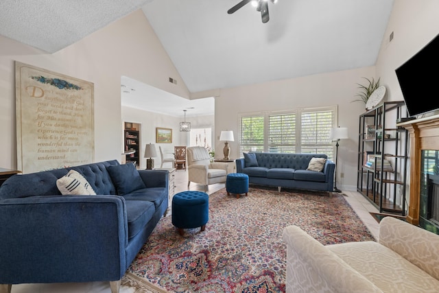 living area featuring baseboards, high vaulted ceiling, ceiling fan, and visible vents