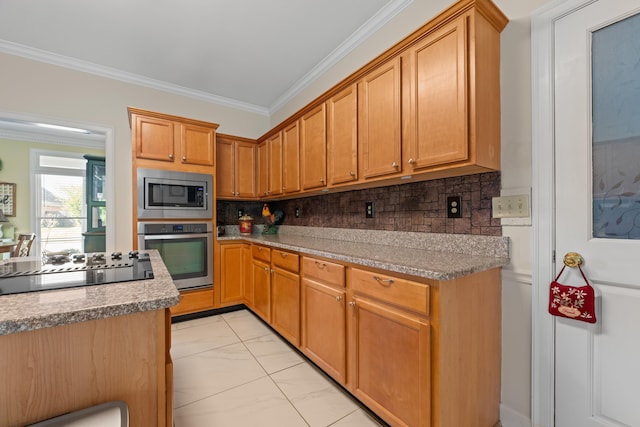 kitchen featuring light countertops, ornamental molding, backsplash, and appliances with stainless steel finishes