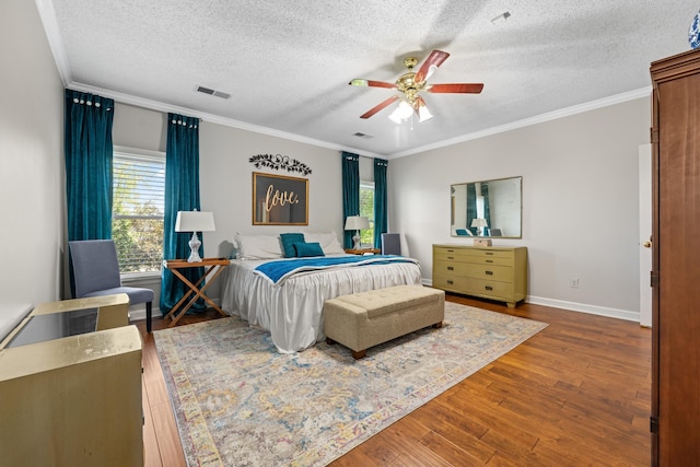 bedroom featuring visible vents, multiple windows, and a textured ceiling