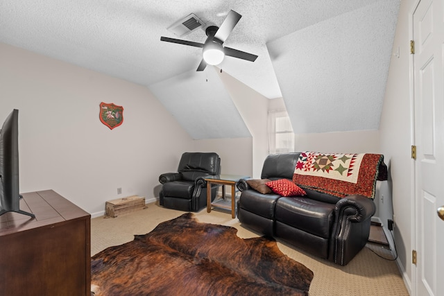 sitting room featuring ceiling fan, a textured ceiling, visible vents, vaulted ceiling, and carpet flooring