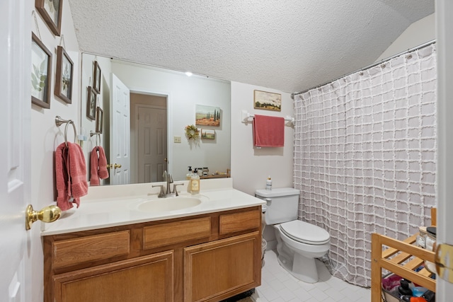 bathroom featuring tile patterned floors, vanity, a textured ceiling, and toilet