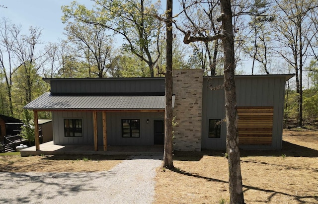 view of front of home featuring a porch, board and batten siding, and metal roof