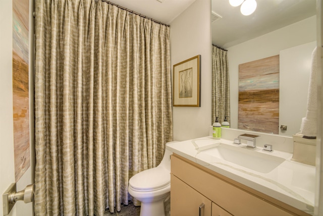 bathroom with toilet and vanity