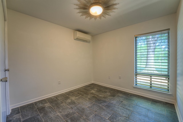 empty room with baseboards and a wall unit AC