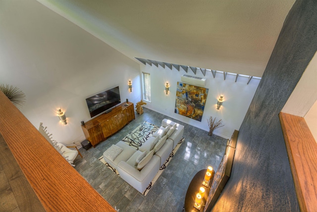 living area featuring wood finished floors and a wall mounted air conditioner