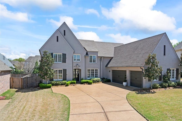 703 Justana Dr, Collierville, TN 38017 - french country home featuring a garage, driveway, a front lawn, and fence