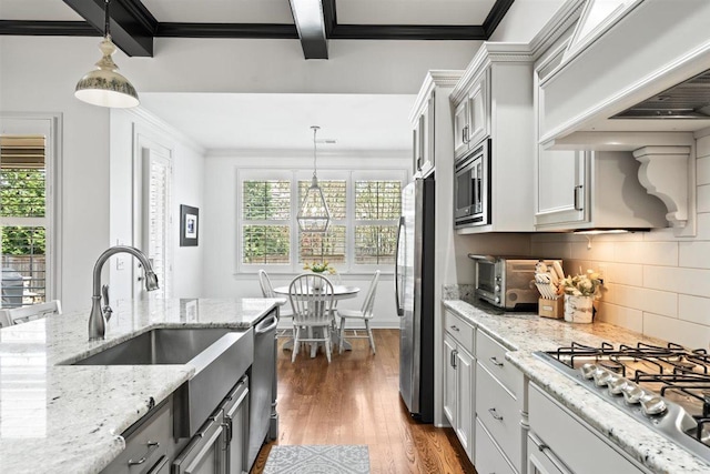 703 Justana Dr, Collierville, TN 38017 - kitchen featuring stainless steel appliances, a healthy amount of sunlight, ornamental molding, and premium range hood