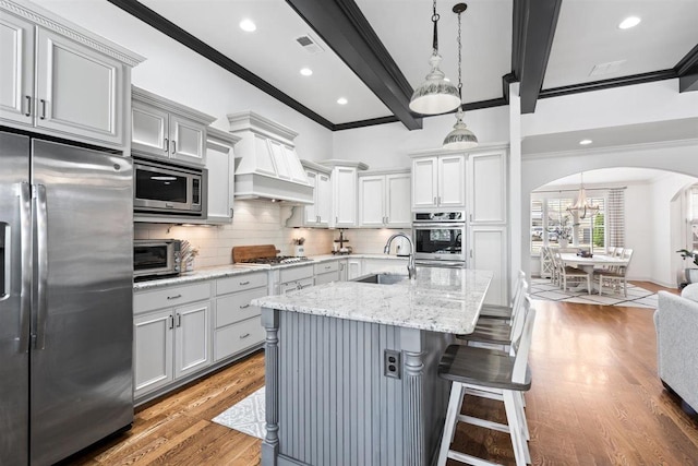 703 Justana Dr, Collierville, TN 38017 - kitchen with crown molding, a sink, arched walkways, stainless steel appliances, and backsplash