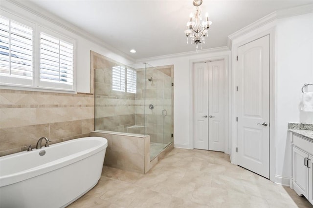 703 Justana Dr, Collierville, TN 38017 - bathroom featuring a freestanding bath, a stall shower, a notable chandelier, vanity, and ornamental molding