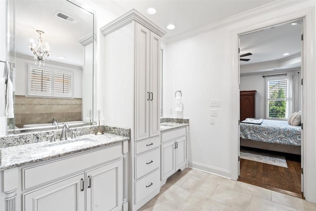 703 Justana Dr, Collierville, TN 38017 - full bathroom featuring visible vents, ornamental molding, a sink, two vanities, and a notable chandelier
