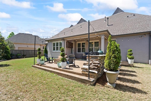 703 Justana Dr, Collierville, TN 38017 - rear view of property featuring fence, a shingled roof, a patio area, a lawn, and an outdoor fire pit