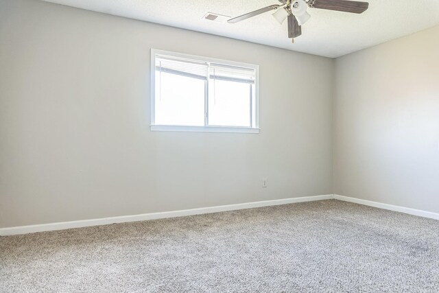 spare room featuring ceiling fan, baseboards, carpet flooring, and visible vents