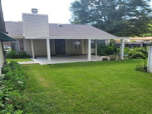 3786 Brandywine Cv, Memphis, TN 38115 - rear view of property with a patio, a chimney, and a yard