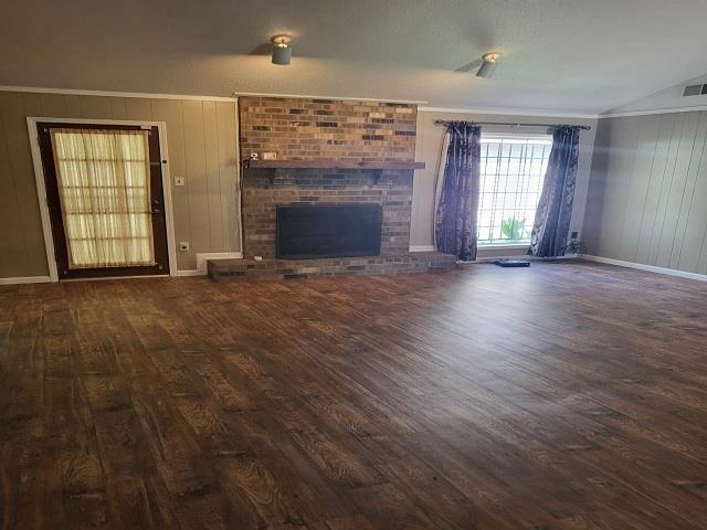 3786 Brandywine Cv, Memphis, TN 38115 - unfurnished living room featuring wood finished floors, a fireplace, lofted ceiling, and crown molding