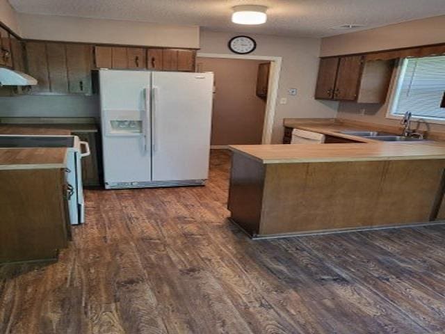 3786 Brandywine Cv, Memphis, TN 38115 - kitchen with white fridge with ice dispenser, ventilation hood, range, a peninsula, and dark wood-style flooring