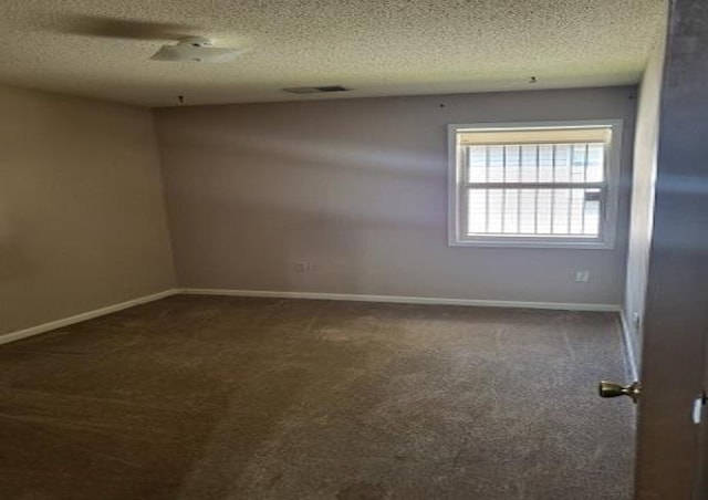 3786 Brandywine Cv, Memphis, TN 38115 - empty room with dark colored carpet and a textured ceiling