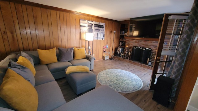 living area with wood walls, wood finished floors, and a fireplace