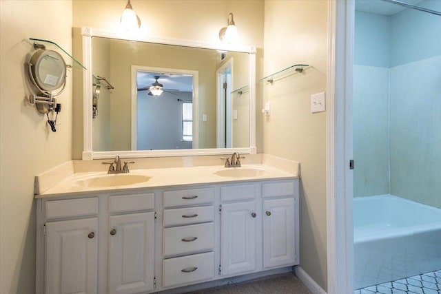 bathroom with a tub, a ceiling fan, a sink, and double vanity