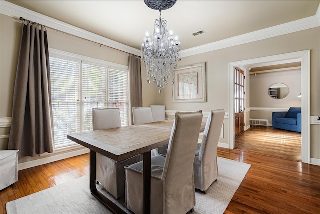 dining area with a notable chandelier, crown molding, visible vents, and plenty of natural light