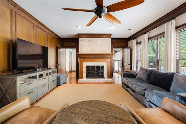 living area with a ceiling fan, wood finished floors, a fireplace, visible vents, and recessed lighting