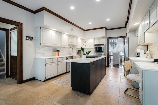 kitchen featuring light countertops, visible vents, ornamental molding, and stainless steel appliances