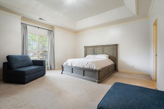 bedroom with a tray ceiling, visible vents, baseboards, carpet floors, and ornamental molding