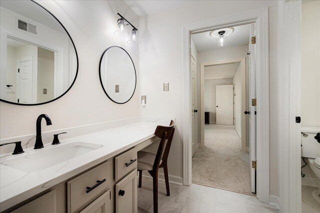 bathroom with vanity, baseboards, toilet, tile patterned flooring, and visible vents