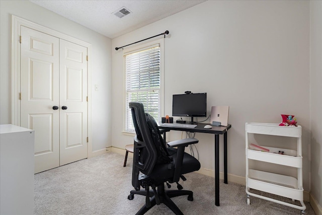 carpeted home office with baseboards and visible vents