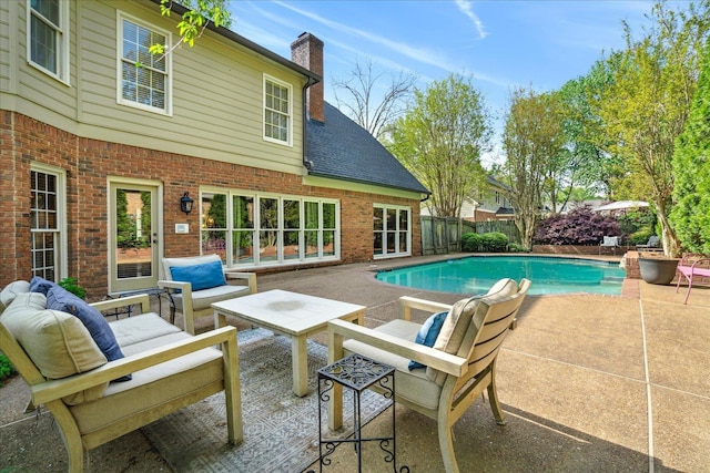 view of pool featuring fence, an outdoor living space, a patio area, and a fenced in pool