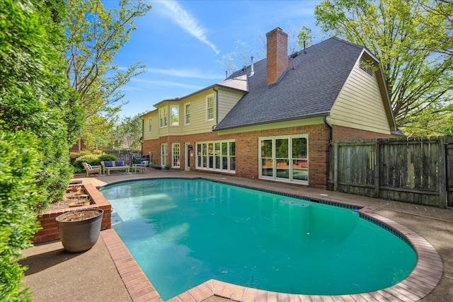 view of swimming pool with a fenced in pool, a patio, and fence