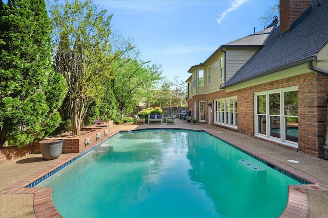 view of pool with fence, a fenced in pool, and a patio