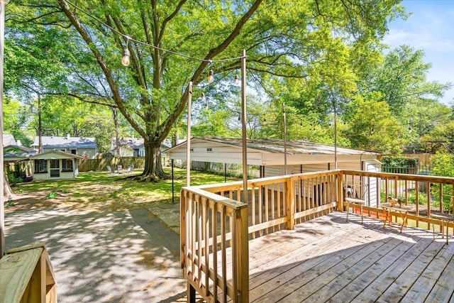 wooden deck with an outdoor structure and fence
