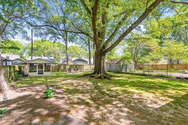 view of yard with a fenced backyard and a sunroom