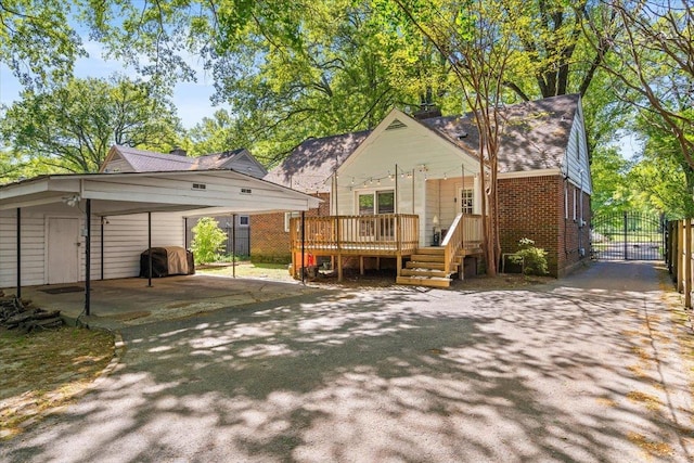 exterior space featuring fence, aphalt driveway, and a gate