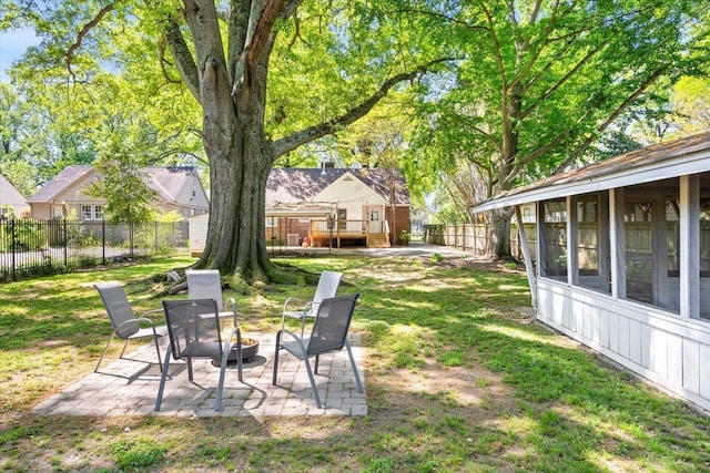 view of yard with a fenced backyard, a patio area, and an outdoor fire pit