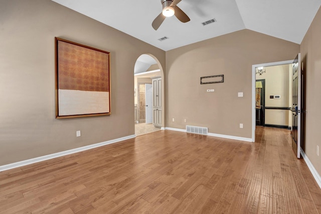 spare room featuring a ceiling fan, visible vents, and arched walkways