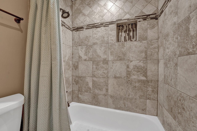 bathroom with shower / tub combo and toilet