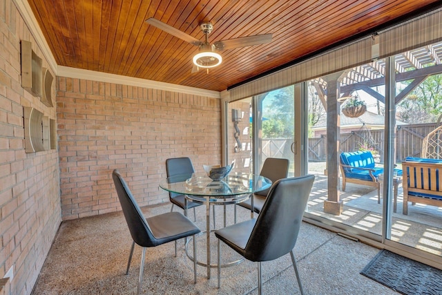 sunroom / solarium featuring a ceiling fan, a wealth of natural light, and outdoor dining area