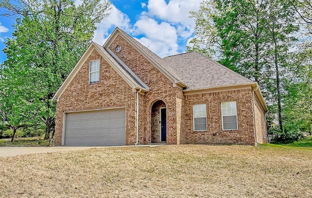 62 Mabel Ln, Atoka, TN 38004 - traditional-style home with driveway, brick siding, a front lawn, and roof with shingles